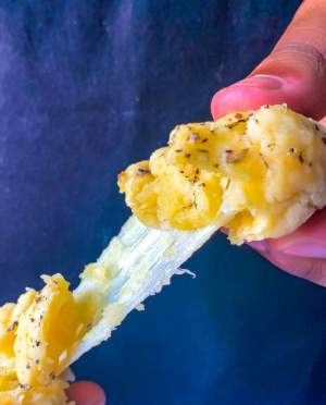 pulling apart cheese bombs with cheese in the middle