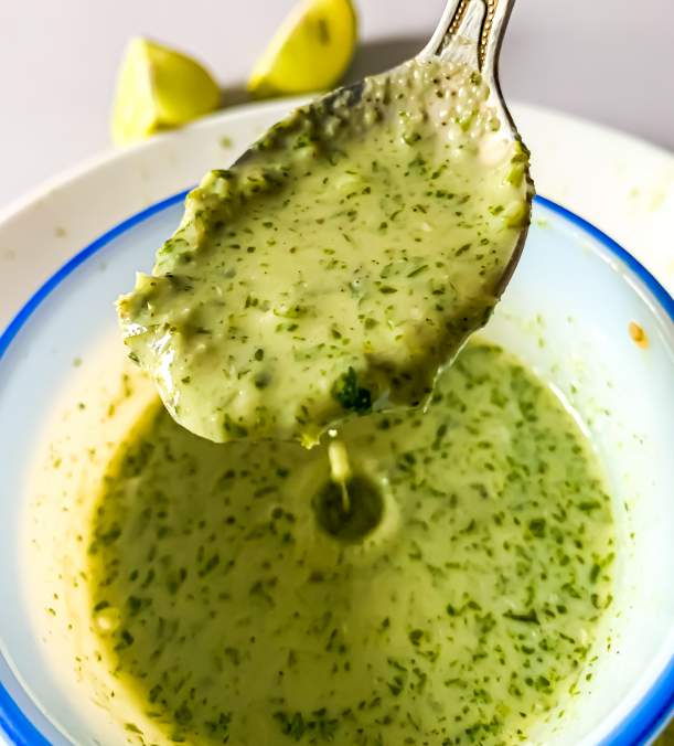 Cilantro Lime Dressing dropping from a spoon