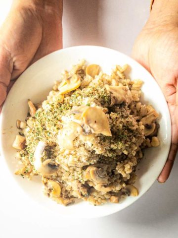 Mushroom Garlic Risotto held by hand