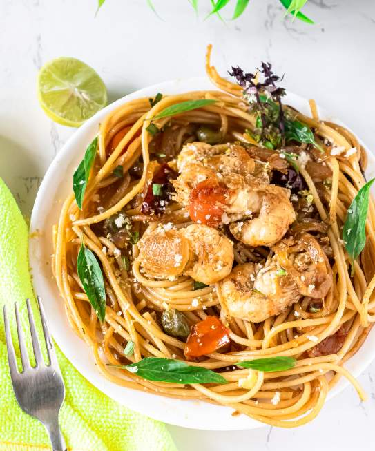 10-min Shrimp Scampi With Spaghetti in a bowl with a fork by its side
