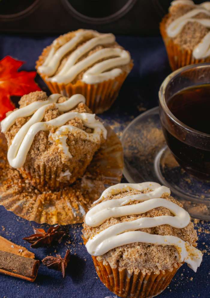 Cinnamon Streusel Pumpkin Muffins arranged on a blue background