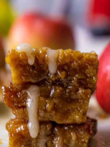 maple glaze dripping from apple crisp bars