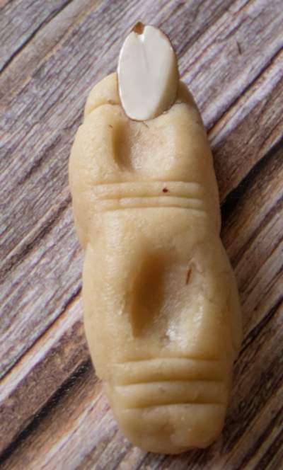 Cookie dough finger with almond on the tip