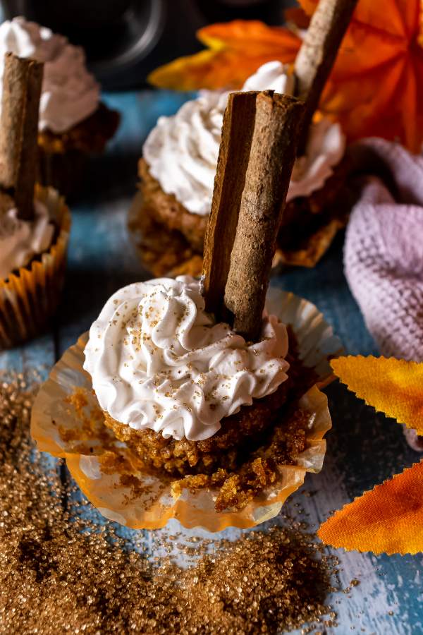 Pumpkin Spice Cupcakes with Maple Buttercream Frosting on a blue table