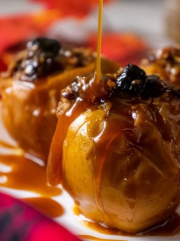 Pouring caramel sauce on baked apples