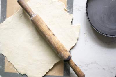 Rolled pie dough with rolling pin on top