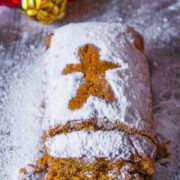 Moist homemade gingerbread loaf cake with powdered sugar on top and loaves cut out
