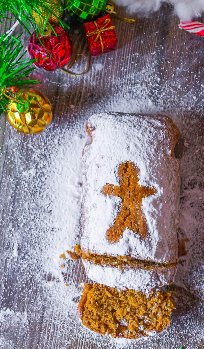 Moist Homemade Gingerbread Loaf with sugar powder dusted around and ornaments around it