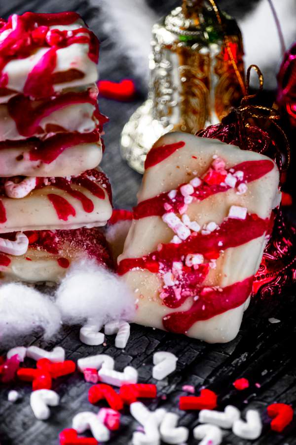 White Chocolate Covered Graham Crackers with Peppermint one kept on the side and others stacked on the side