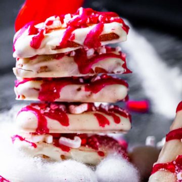 Stack of White Chocolate Covered Graham Crackers with Peppermint with stocking hanging in the back