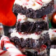 Stack of White Chocolate Peppermint Brownies with candy cane on the side