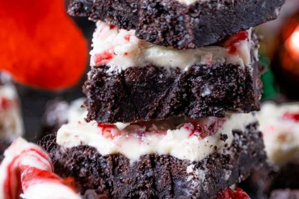 Stack of White Chocolate Peppermint Brownies with candy cane on the side