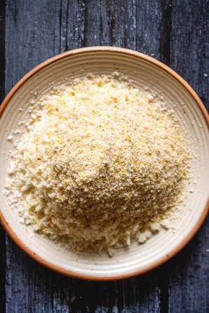 a plate with parmesan cheese and breadcrumbs