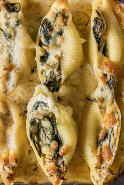 close up of Spinach Ricotta Stuffed Shells in Alfredo Sauce 