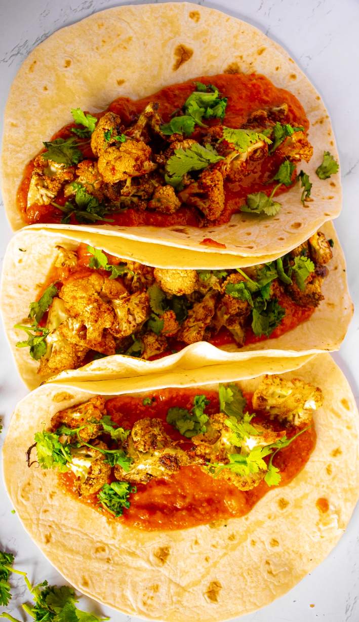 Crispy Roasted Cauliflower Tacos with Chipotle Romesco with cilantro on top