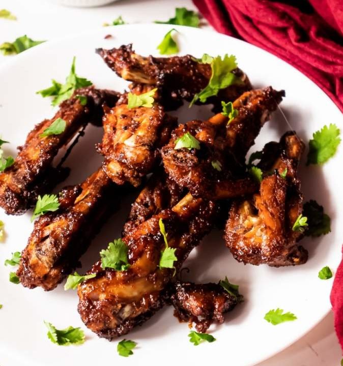 crispy cajun chicken wings on a white plate
