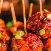 firecracker chicken meatballs on a plate with toothpicks