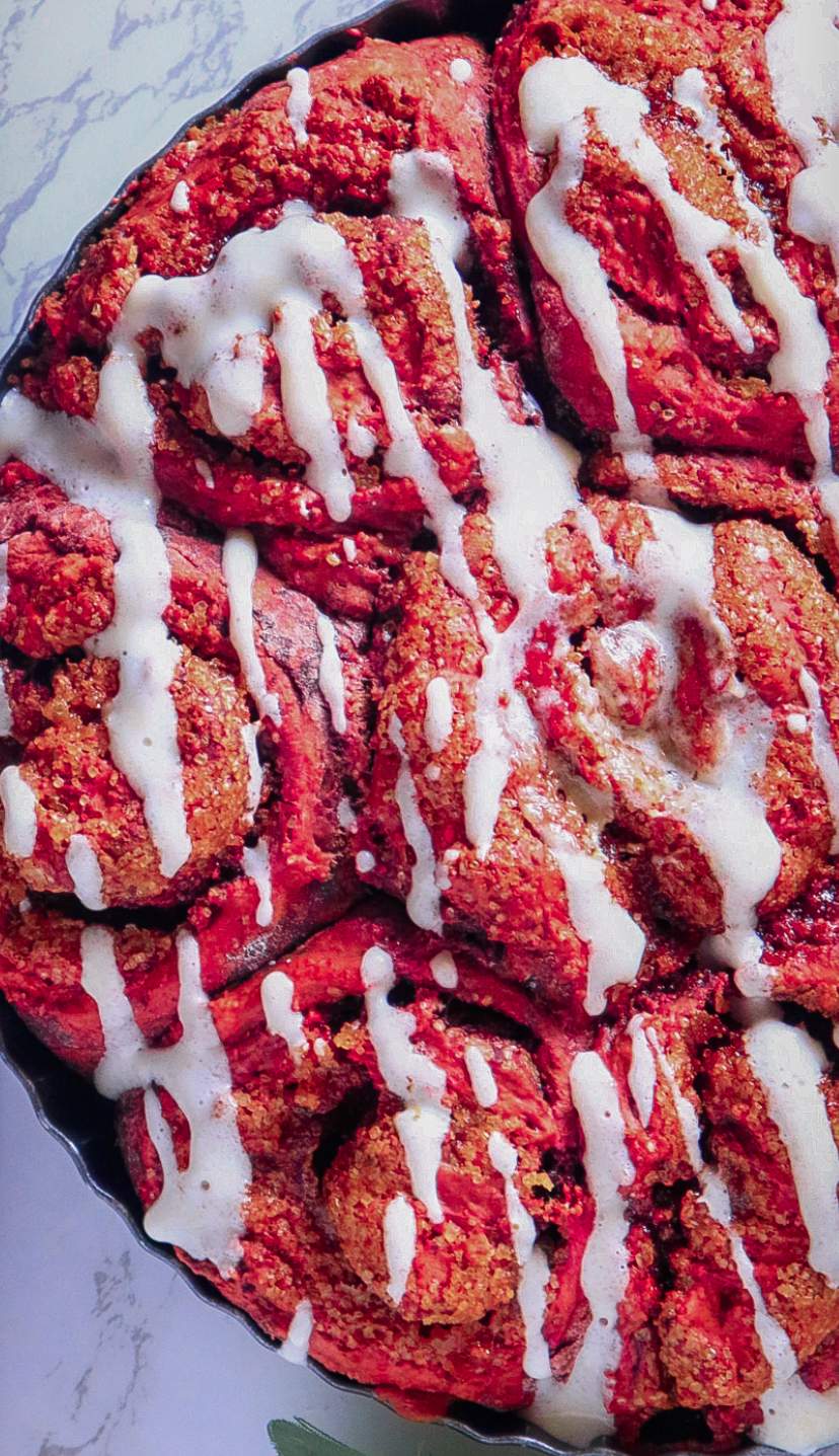 Red Velvet Cinnamon Rolls Recipe from scratch in a plate on a white table