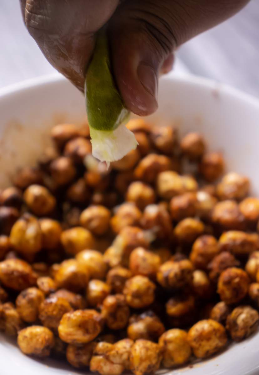 squeezing lime juice on chickpeas