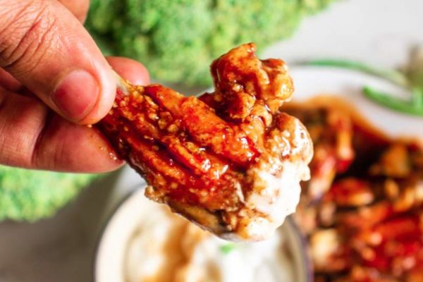 baked buffalo wings in a plate with dipping sauce
