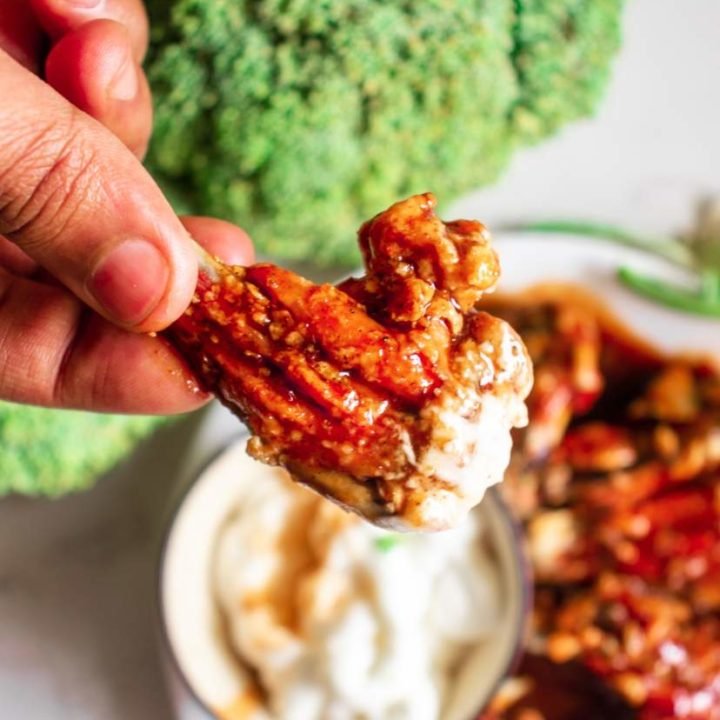 baked buffalo wings in a plate with dipping sauce