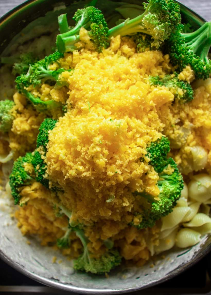 adding broccoli and cheese to Broccoli Mac and Cheese