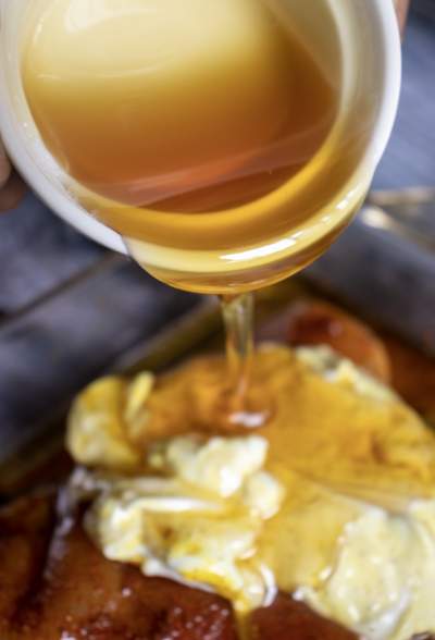 pouring honey over chicken breasts