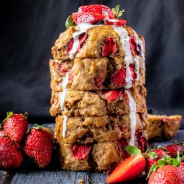 Strawberry Banana bread on a table with strawberries