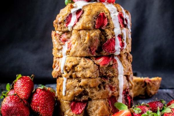 Strawberry Banana bread on a table with strawberries