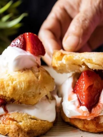 Strawberry Shortcake with hands keeping the last biscuit on top