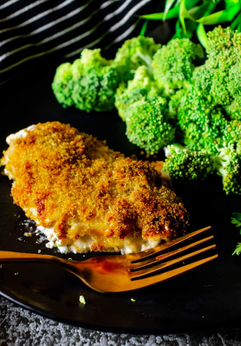 ranch cheddar chicken on a black plate with broccoli in the background