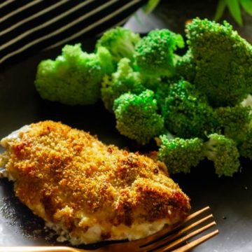 ranch cheddar chicken bake on a black plate with fork and broccoli on the back