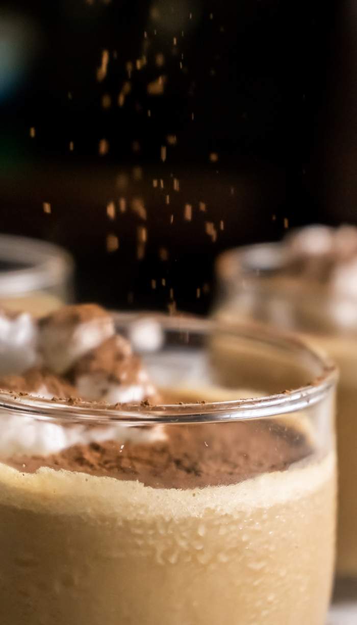 dusting cocoa powder over Coffee Mousse 