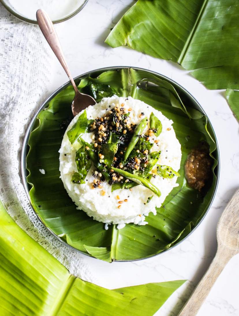 overhead shot of curd rice with banana leaves
