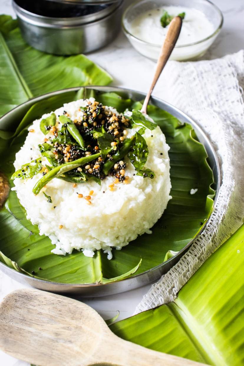 curd rice on banana leaf with spoon in the rice