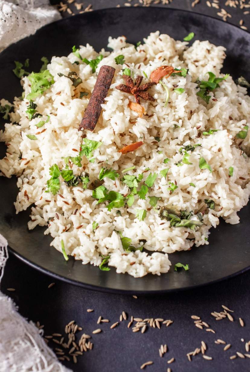 jeera rice on a black plate
