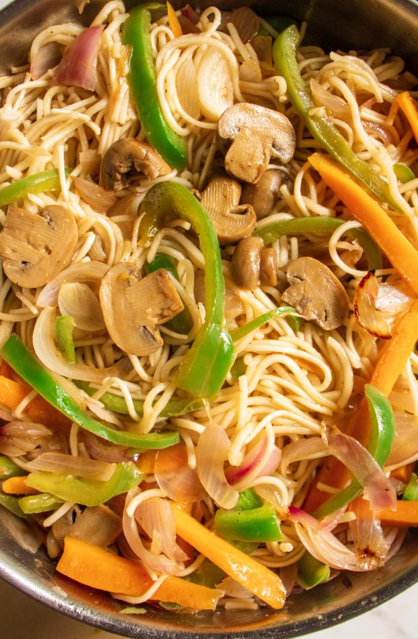 Vegetable Chow Mein in a skillet with mushrooms bell pepper and carrots
