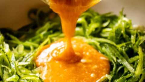 Pouring Bang bang Sauce on Zucchini Noodles