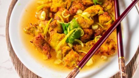 keto lemon chicken on a white plate with chopsticks