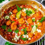 greek shrimp with tomatoes and feta in a skillet