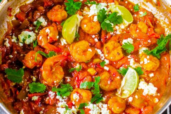 greek shrimp with tomatoes and feta in a skillet