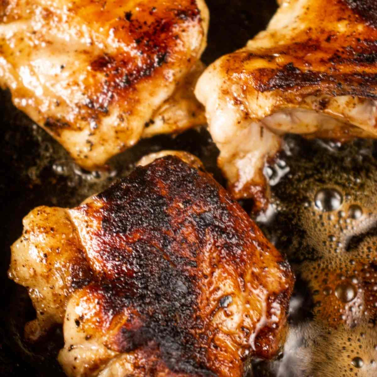searing chicken in a skillet 