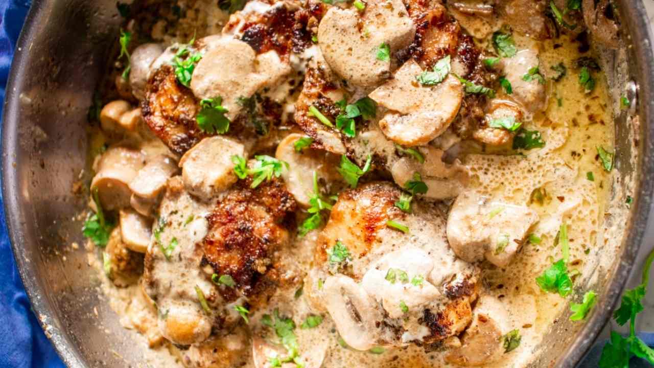 chicken thigh in creamy mushroom garlic sauce in skillet
