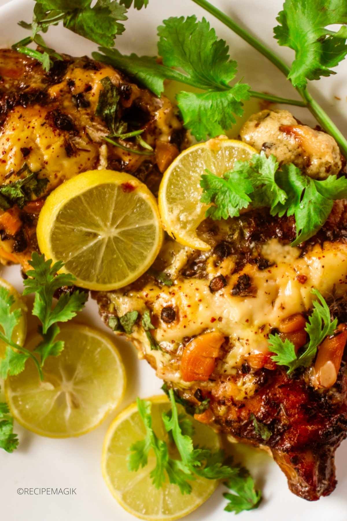 chicken thighs with parsley and lemon wedges