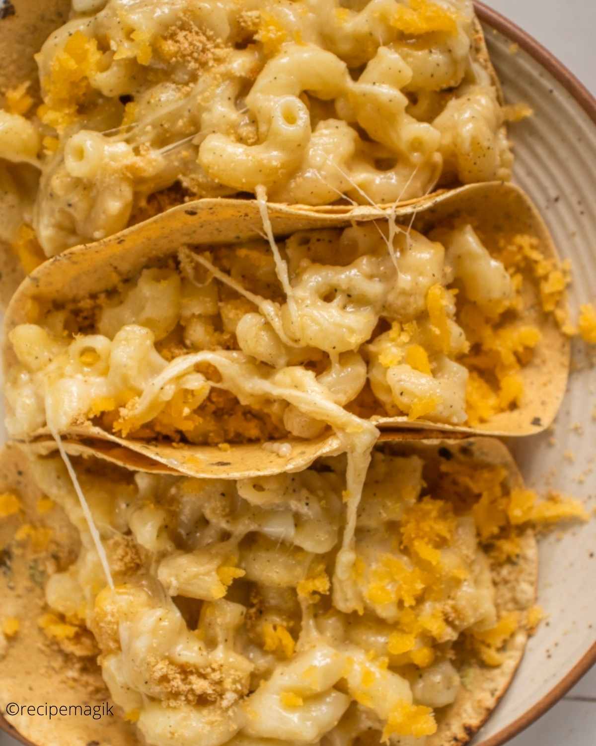 overhead shot of mac and cheese tucked in tacos