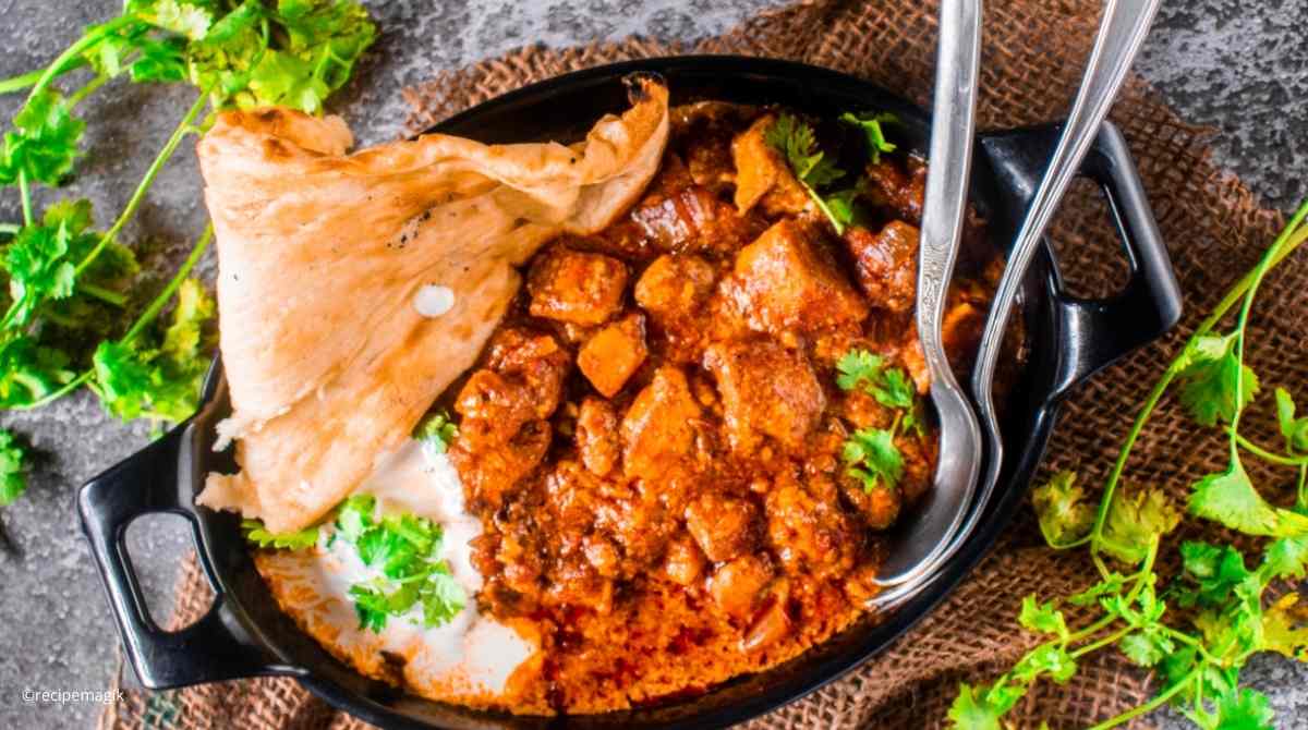 overhead shot of slow cooker butter chicken with burlap background