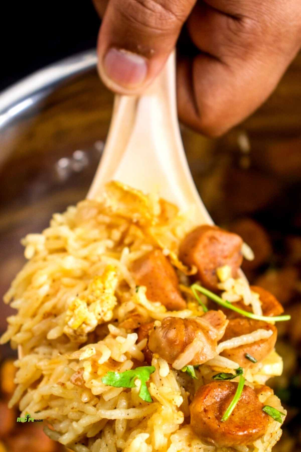 closeup of smoked sausage with basmati rice in a spatula