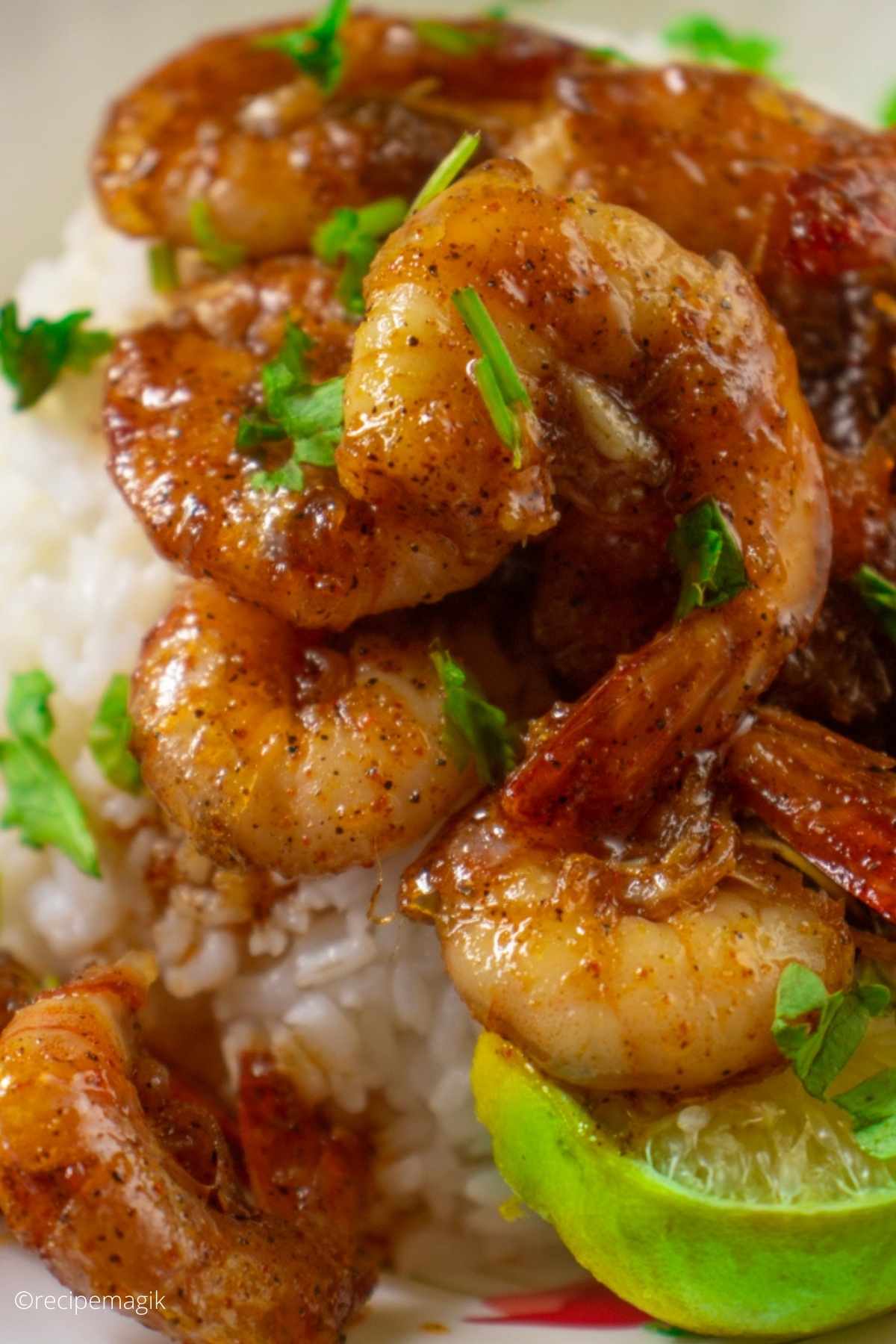shrimps glazed with honey served over rice with lime wedge on the side