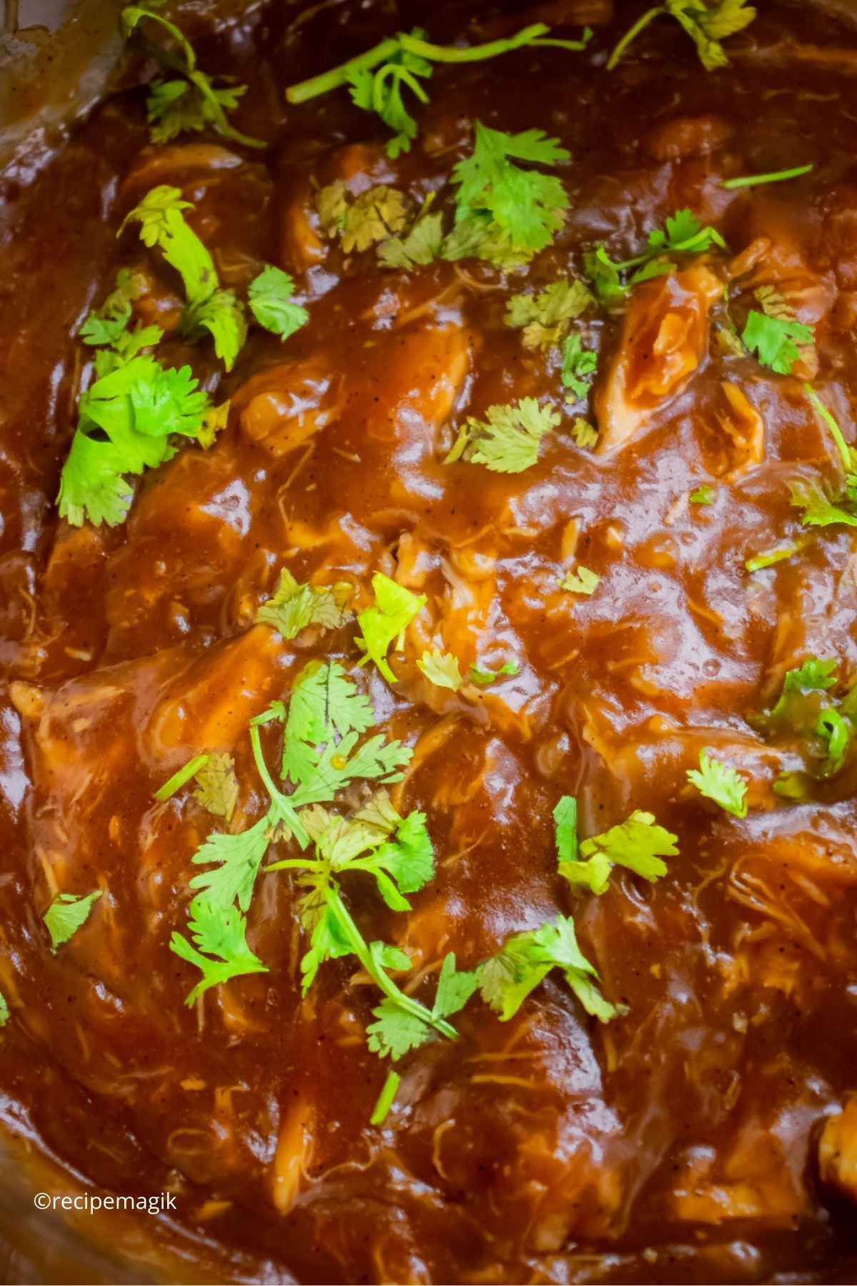 bbq chicken in an instant pot garnished with parsley