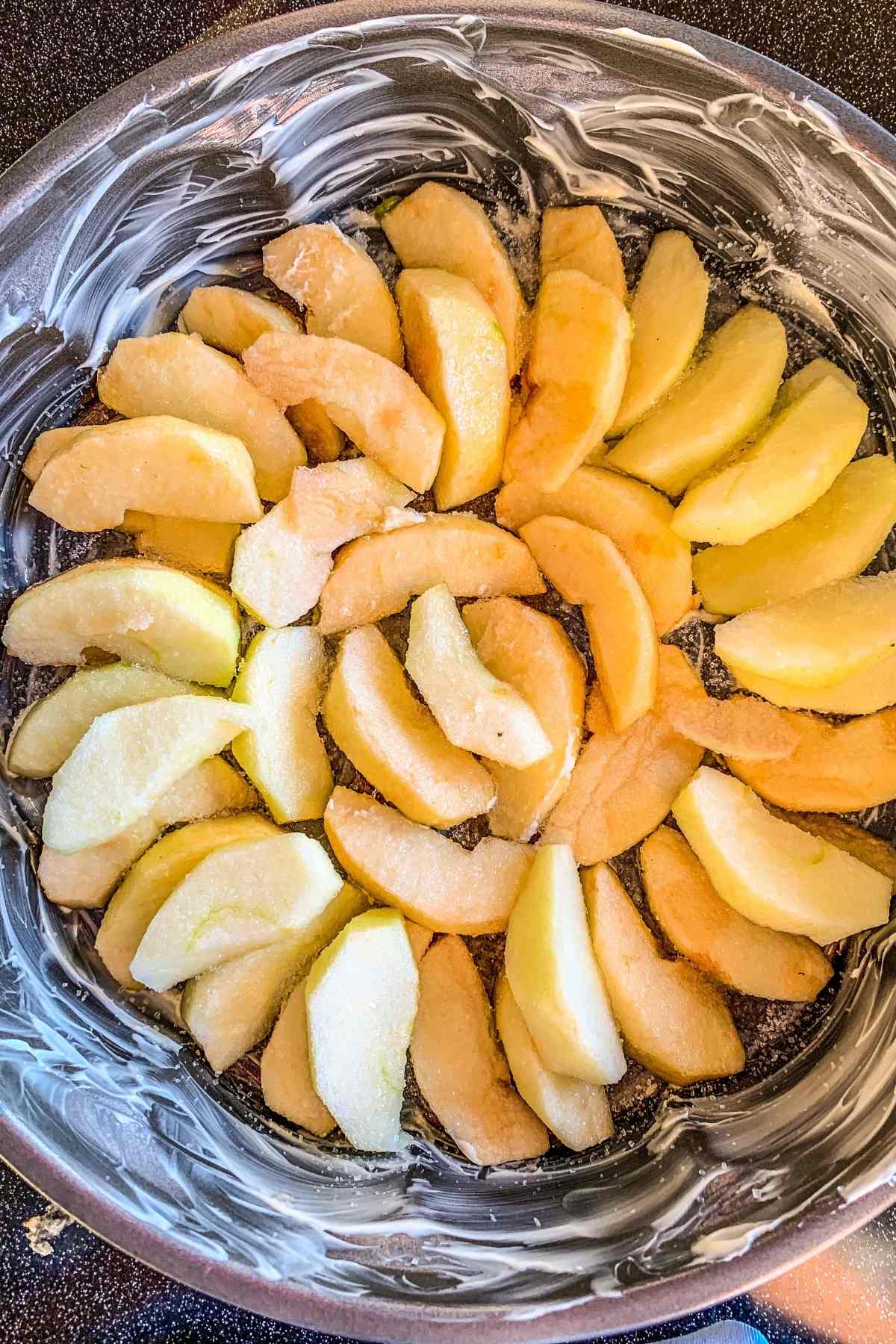 sliced apples in a pie dish